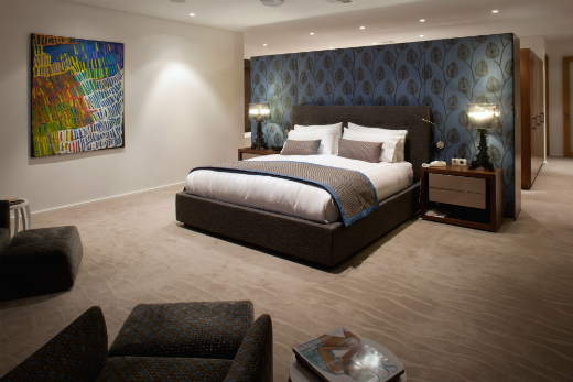 Upholstered walls in silk and custom designed furniture give a luxurious feel to this room.